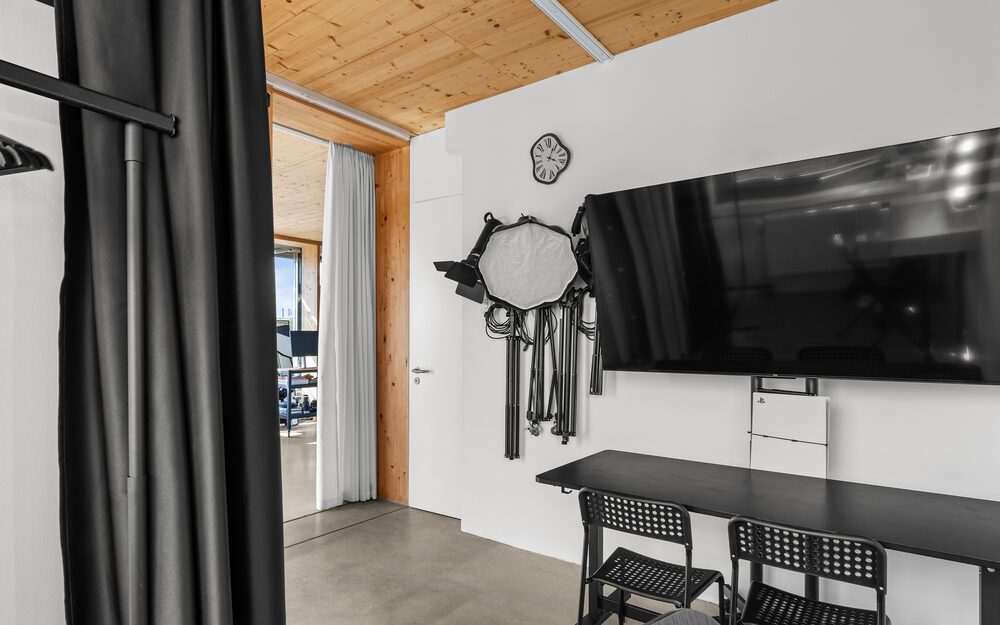 65-inch review monitor on the studio wall